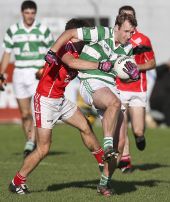 Seán O'Hare struggles to free himself from the shackles of his Stradbally opponent during the County Senior Football Championship Final at Fraher Field