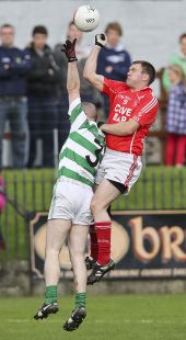 Shane Briggs challenges for possession during the County Senior Football Championship Final at Fraher Field