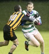Eoin Enright attempting to break the tackle of his marker during the Western Intermediate Football Championship Final played at Fraher Field