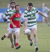 James O'Mahony solos away from his opponent during the County Senior Football Championship match v Clashmore at Fraher Field