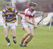 James O'Mahony concentrates on winning possession from his De La Salle opponet during the County Senior Hurling Championship clash at Walsh Park