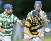 The Hurney brothers, Gary and John, attempt to dispossess their Lismore opponent during the County Senior Hurling Championship game at Fraher Field