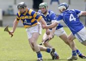 Maurice Power breaks free from two Fourmilewater players during the first round County Senior Hurling Championship clash at Fraher Field