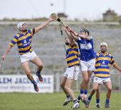 Richie Foley jumps high in an attempt to secure the sliothar during the County Senior Hurling Championship Quarter Final at Walsh Park. James O'Mahony and Mark Ferncombe are ready for any breaks.