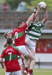 Patrick Hurney climbs highest to catch clean ball during Ballinacourty's County Senior Football Championship encounter with Clashmore at Fraher Field