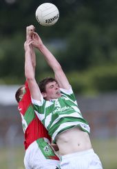 Patrick Hurney in a battle for possession with his Clashmore counterpart during the County Senior Football Championship clash at Fraher Field