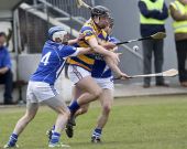 Shane O'Donovan battles to free himself from the shackles of the Fourmilewater attackers during the County Senior Hurling Championship at Fraher Field