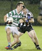 Michael O'Halloran holds off his St. Saviour's opponent during the County Senior Football Championship Quarter Final played at Fraher Field