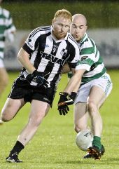 Shane Briggs steals possession from his St. Saviour's opponent during the County Senior Football Championship Quarter Final at Fraher Field